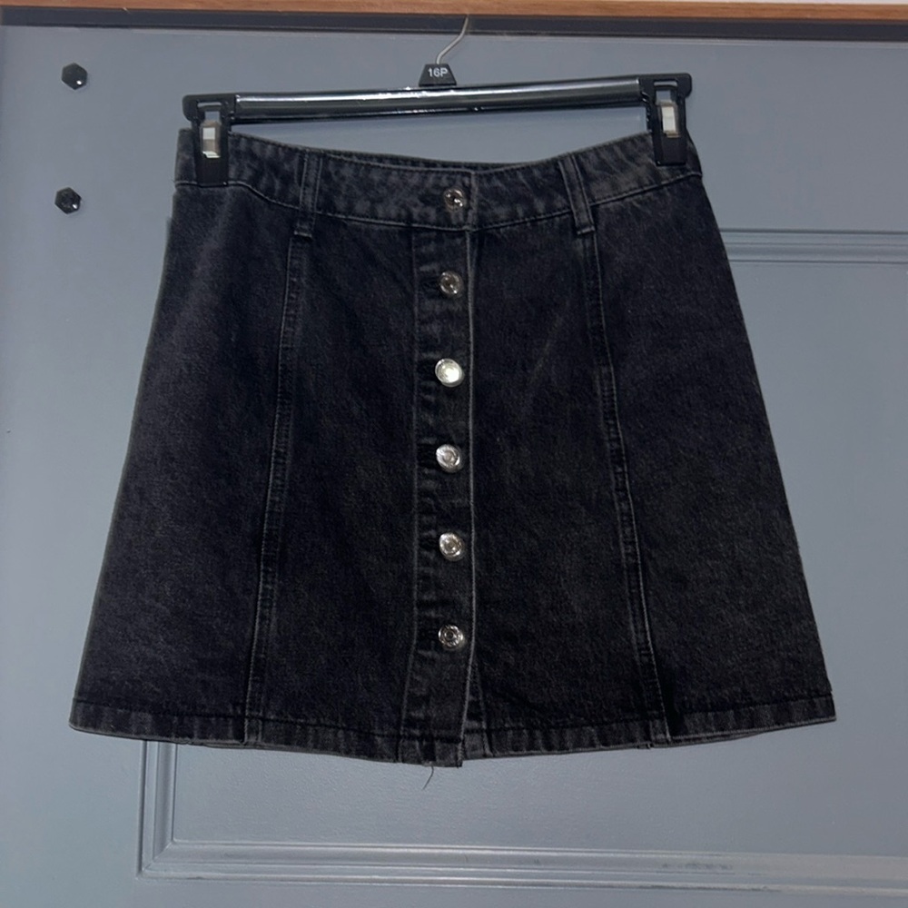 This medium, black, denim skirt is a cute piece when fall comes around.